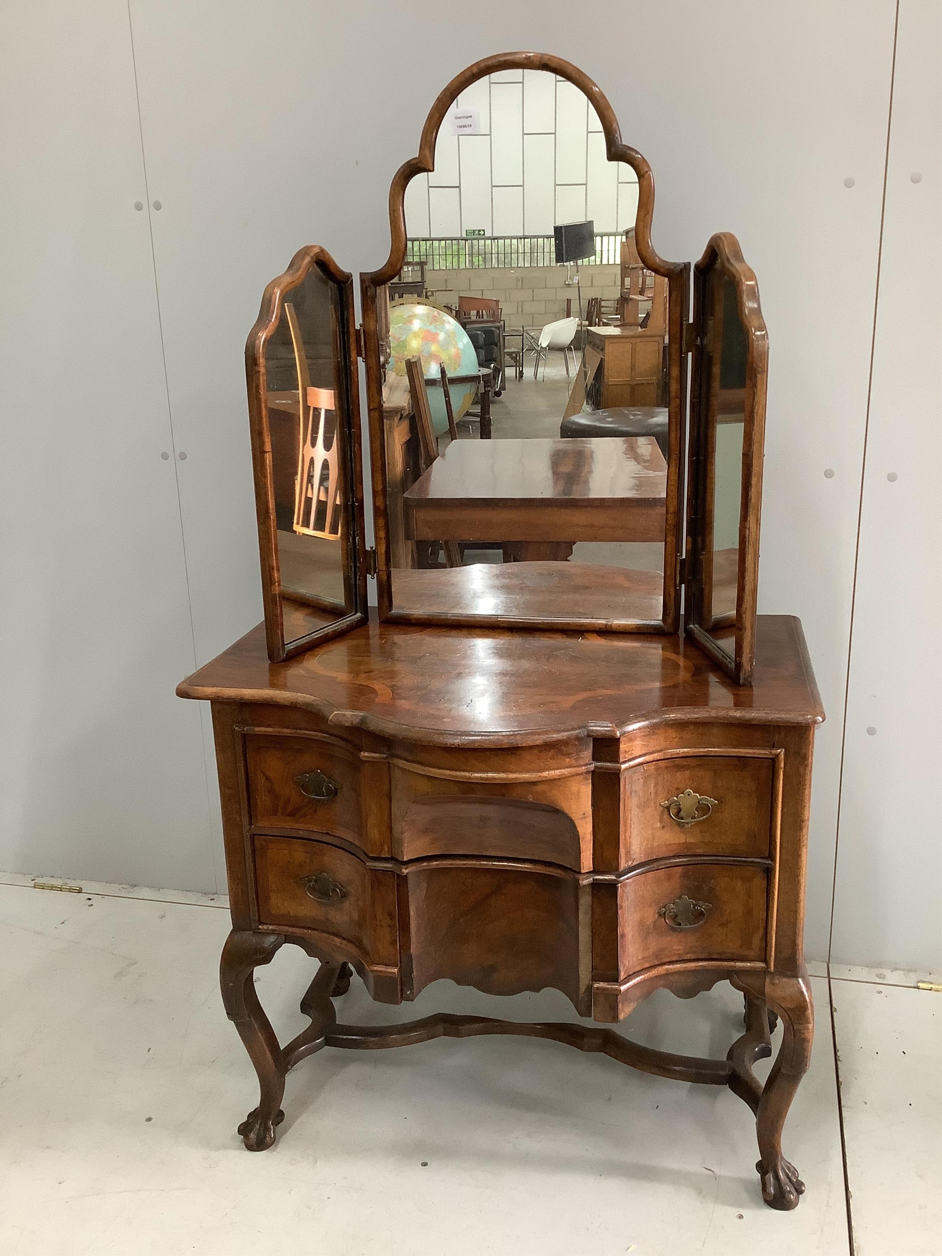 A 19th century Dutch serpentine walnut dressing table with associated triptych mirror, width 83cm. Condition - fair, some losses